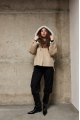 Stylish suede sheepskin coat made of natural sheepskin in beige color with a hood